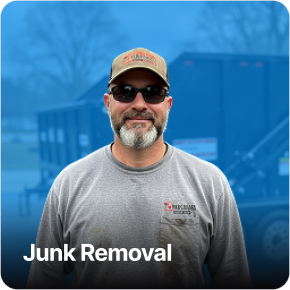 Worker carrying a large item for junk removal service.