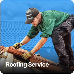 Smiling handyman in overalls holding tools.